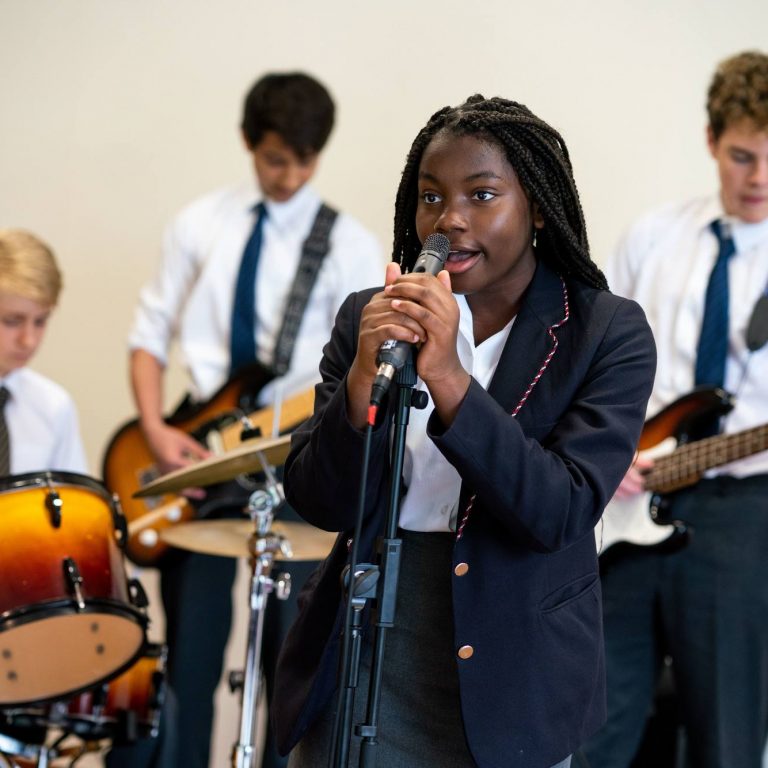 students in a band, with one singing