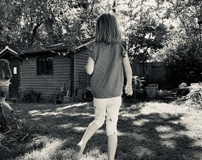 girl in front of a shed