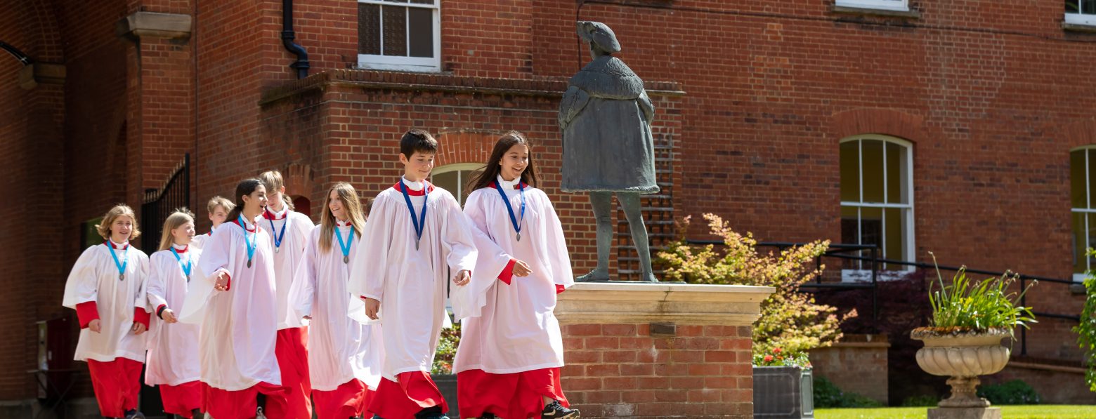 students in white and red robes